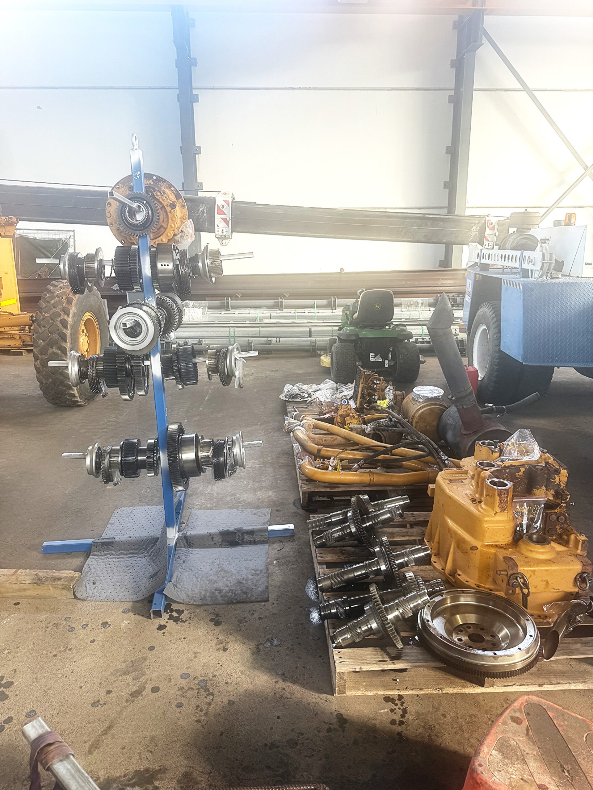 Heavy-duty machinery parts and components in a workshop for maintenance and repair.