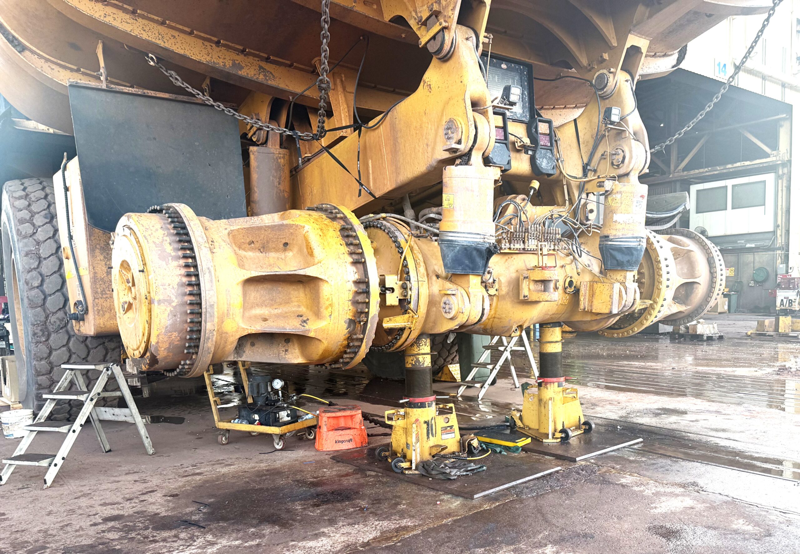 Mining truck under maintenance in a service facility.