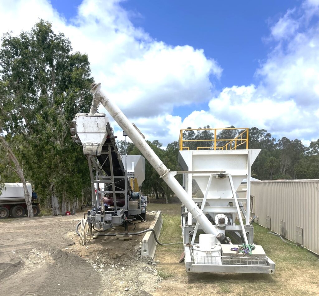 A concrete batching plant in operation, blending raw materials to create ready-mix concrete.
