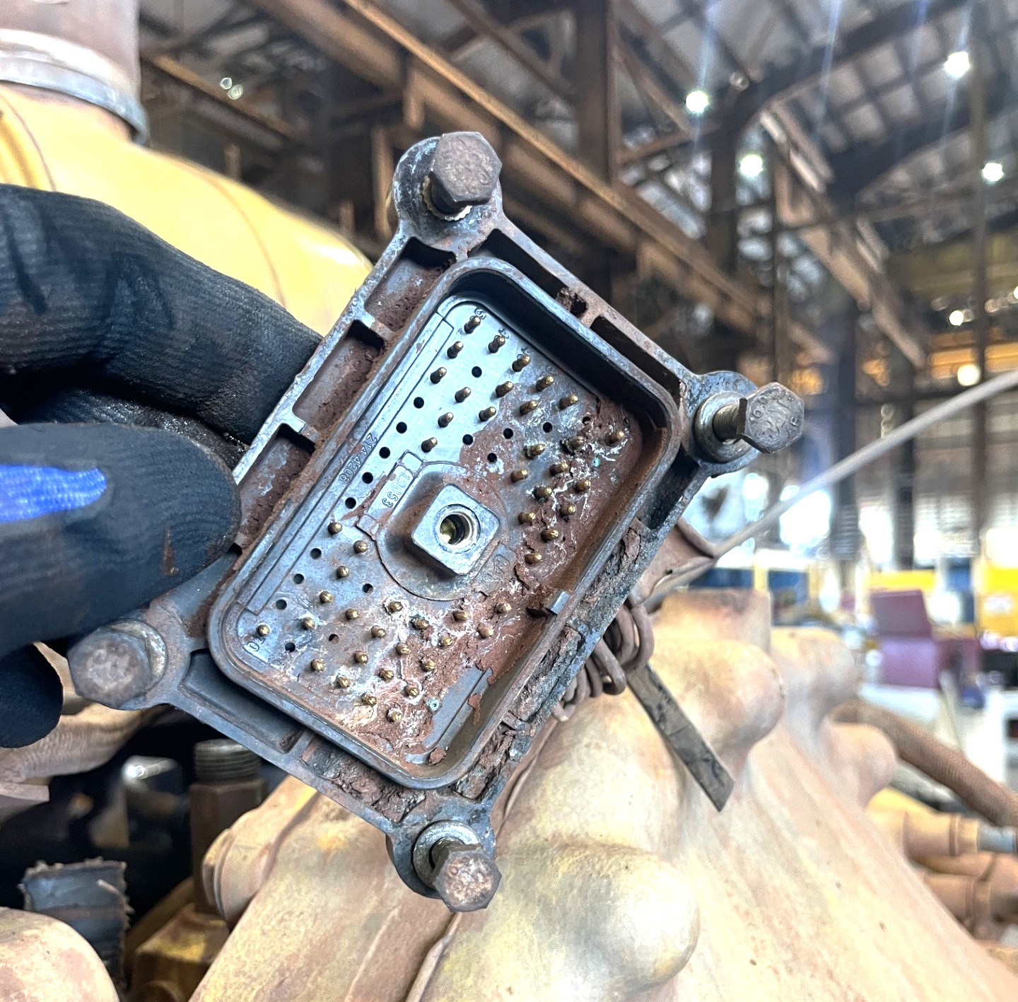 Engine control module showing corrosion and damaged connectors.